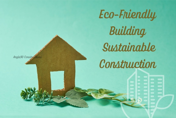 Sustainable construction concept promoted by Angle90 Constructions in Coimbatore, featuring an eco-friendly cardboard house model surrounded by green foliage, representing environmentally conscious building practices.