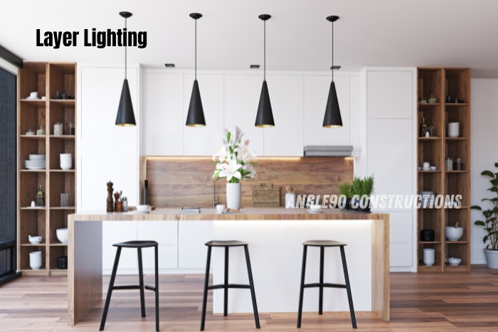 Modern kitchen with layer lighting design by Angle90 Constructions, the leading interior design experts in Coimbatore. Perfect blend of style and functionality for your dream home