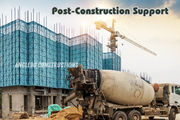 Angle90 Constructions providing reliable post-construction support for a large commercial project in Coimbatore, with concrete mixing trucks on-site and scaffolding in place for final touches