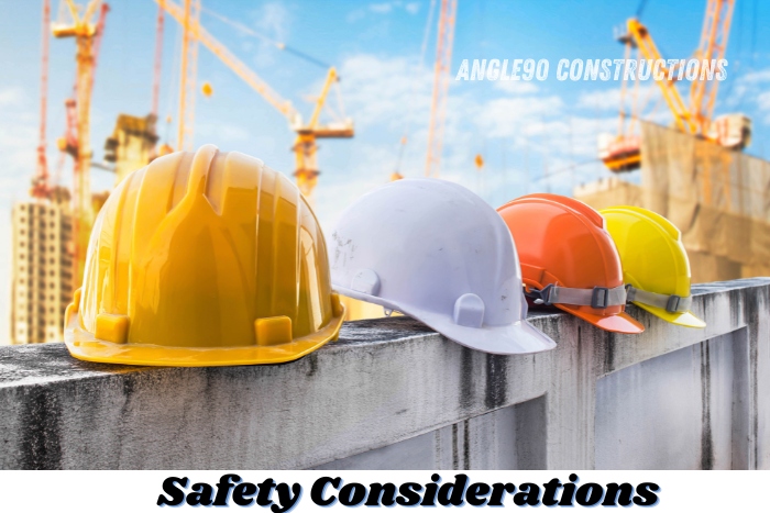 Construction safety helmets in various colors placed at a worksite, representing safety considerations at projects managed by Angle90 Constructions in Coimbatore