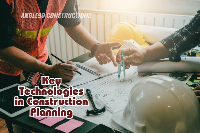 Construction experts discussing blueprints and digital tools at Angle90 Constructions, Coimbatore