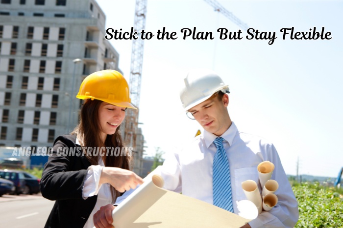 Angle90 Constructions engineers reviewing BUILDING plans on-site in Coimbatore