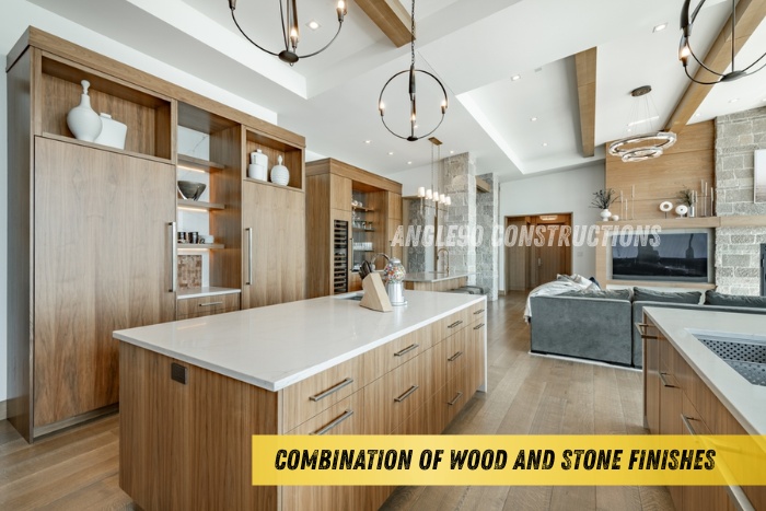 Modern kitchen and living space in Coimbatore featuring a combination of wood and stone finishes with premium interiors